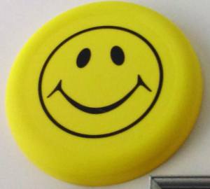 yellow frisbee with a happy face