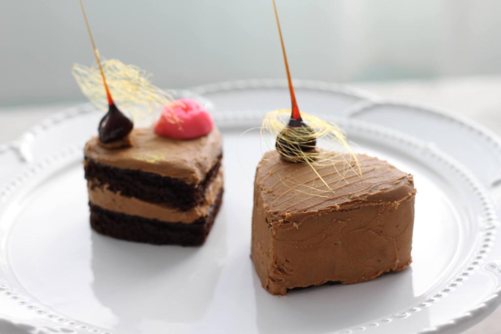 Two small heart-shaped chocolate cakes with burnt sugar spikes, by @butteraimee