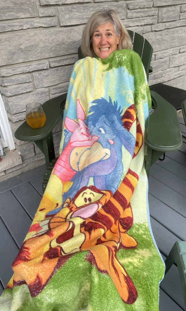 Arlene Smith on her front porch under a Winnie the Pooh blanket