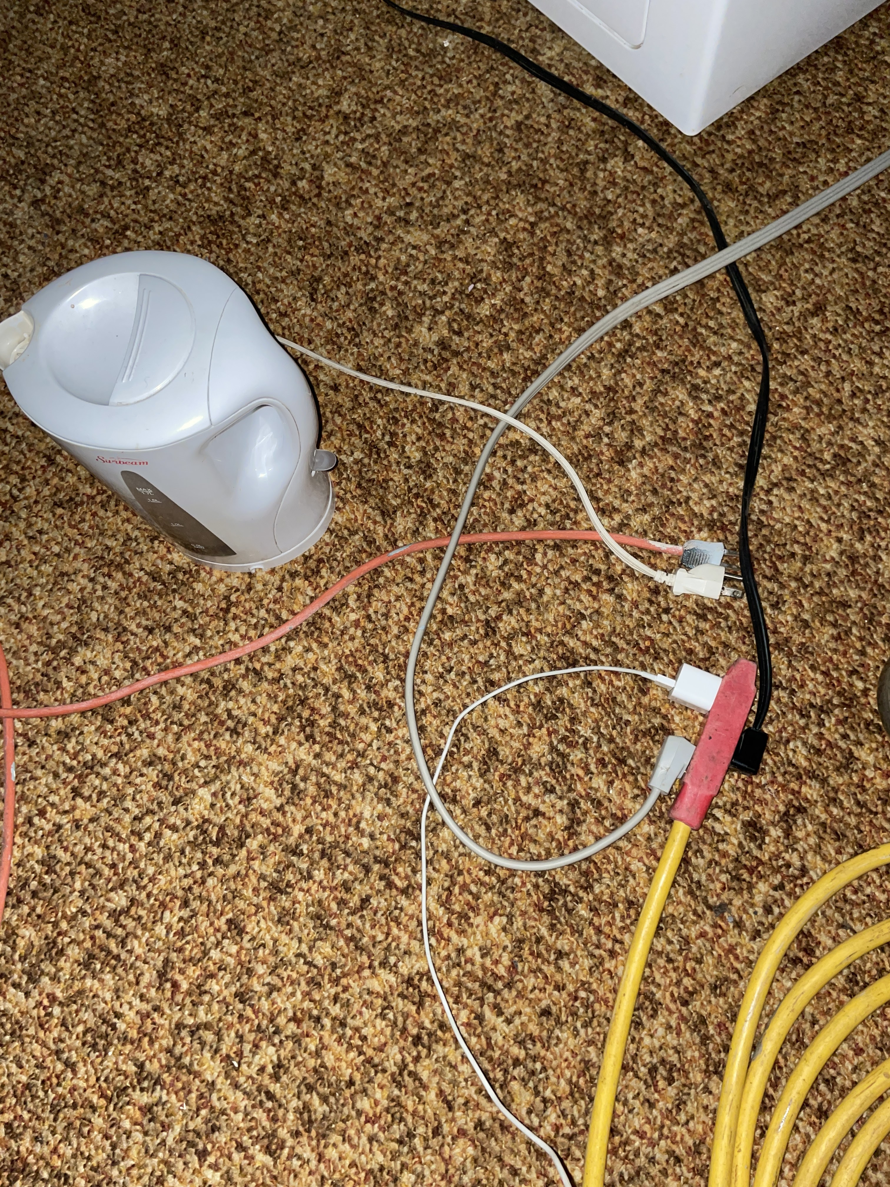 A temporary set-up for power when the generator ran. One cord leads to a freezer, another to a kettle and another to a phone charger. 