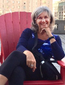 Arlene Somerton Smith seated on a red chair on the patio beside the National Arts Centre, Ottawa, Ontario, Canada