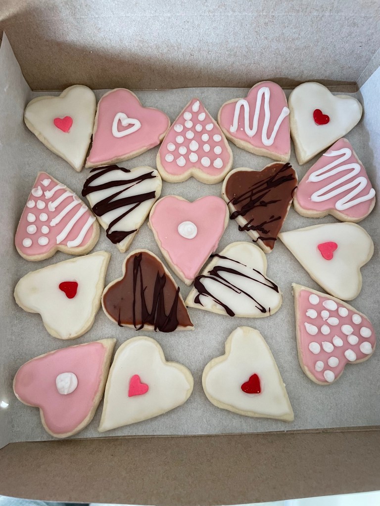 A box of decorated Valentine cookies. 